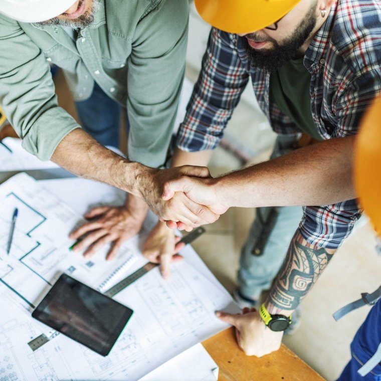 Contractors shaking hands over job plans