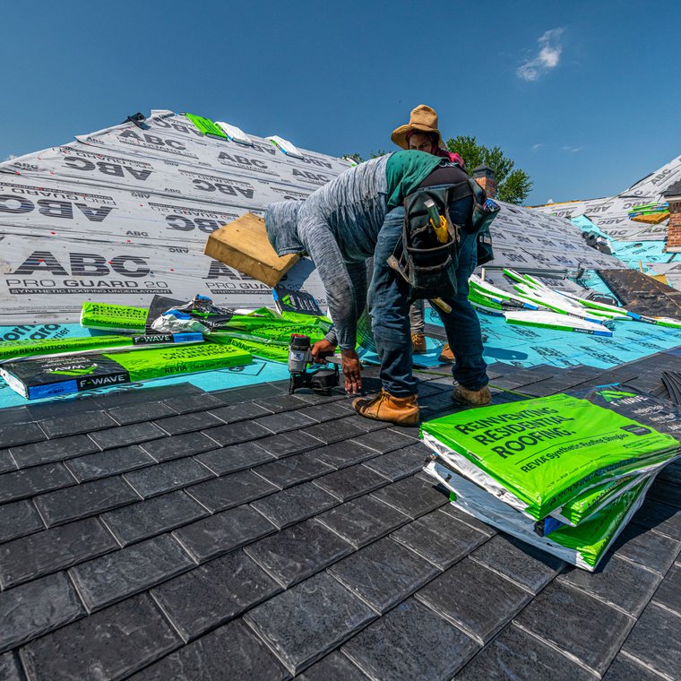 Roofing crew working on a residential roof
